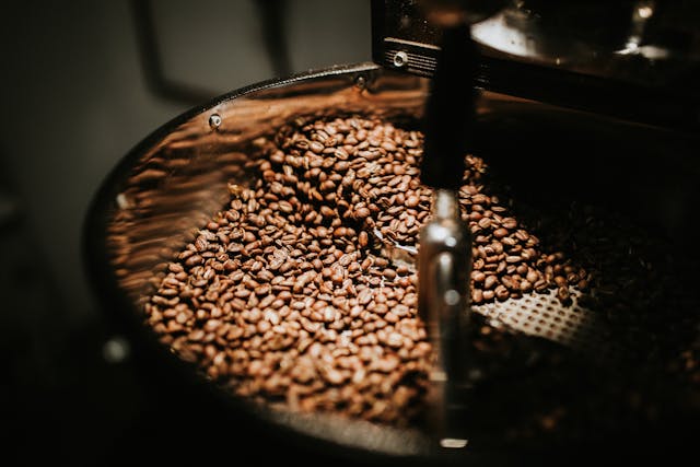 a batch of coffee beans in a large mixer